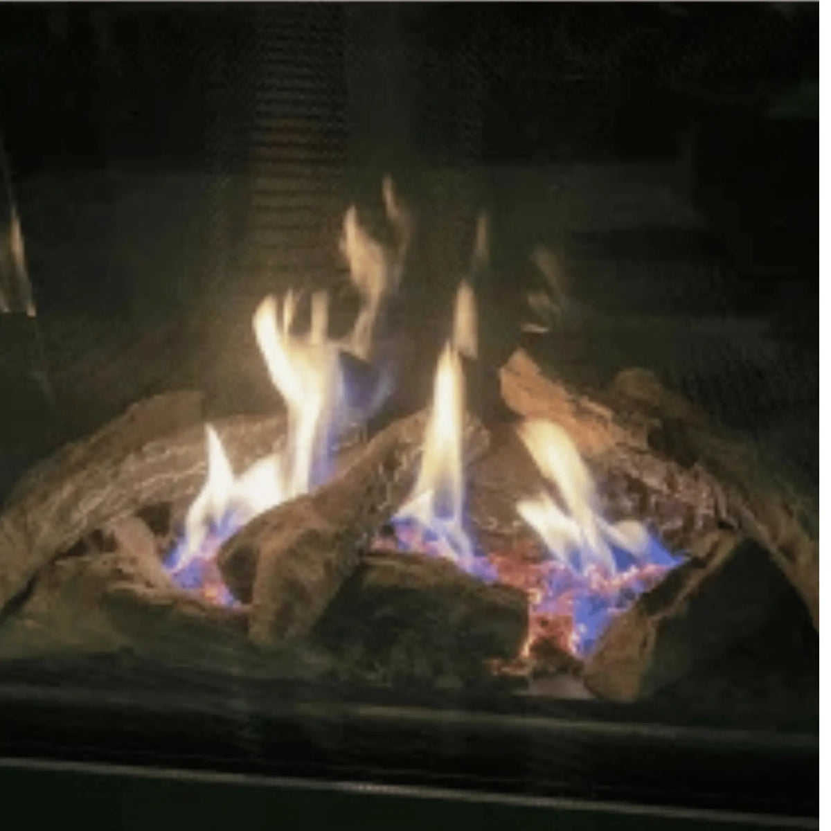 Close-up of gas flames over a ceramic log set in the Sierra Flame Thompson fireplace