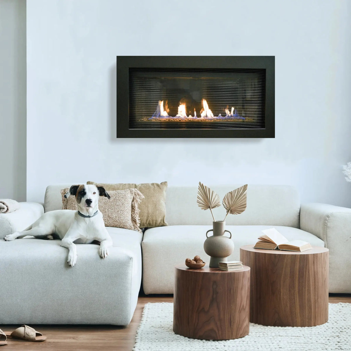 Sierra Flame Bennett 45 linear gas fireplace with black surround on a pale wall above a cream sofa