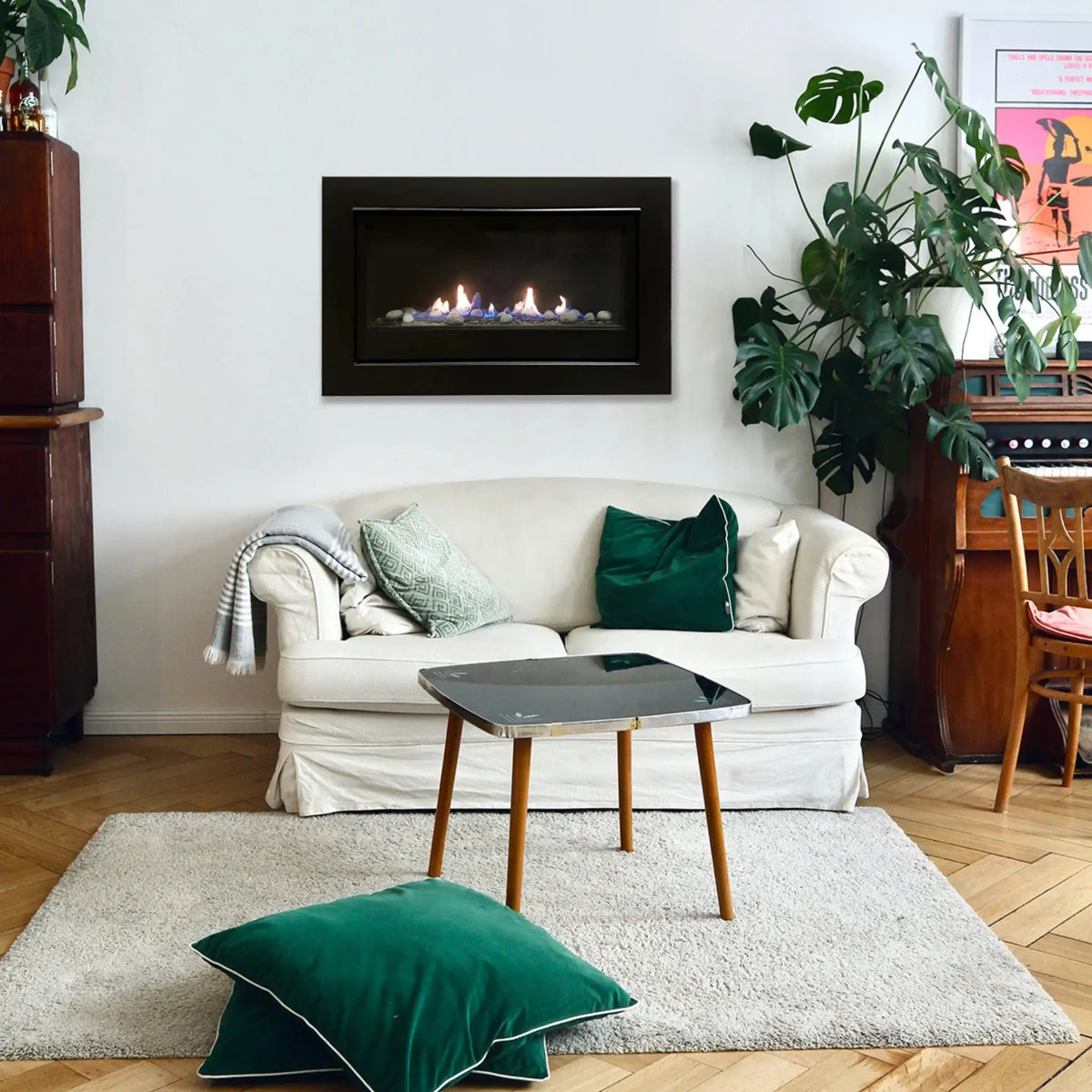 Sierra Flame Boston 36 compact linear gas fireplace on a white wall above a cream loveseat
