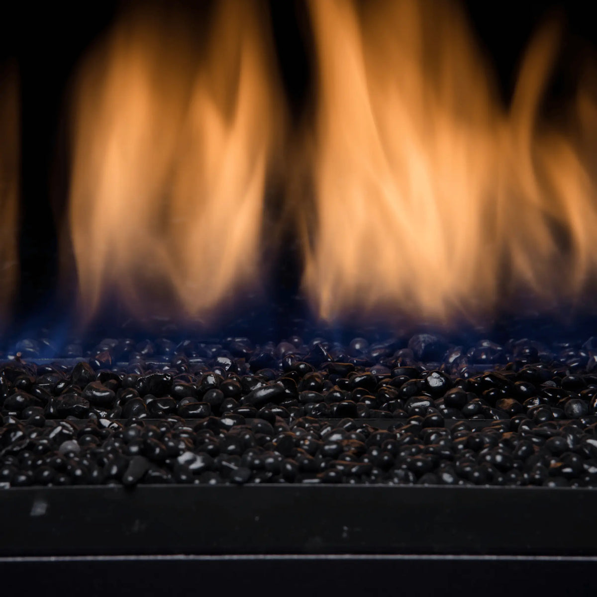 Close-up of gas flames over black glass media in a Sierra Flame Palisade fireplace