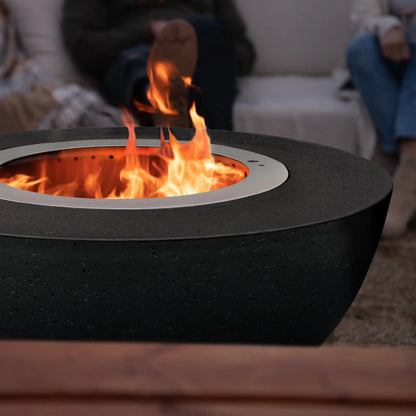 LUME Surround 1 Raven black GFRC smokeless fire pit with flames rising from the stainless steel insert