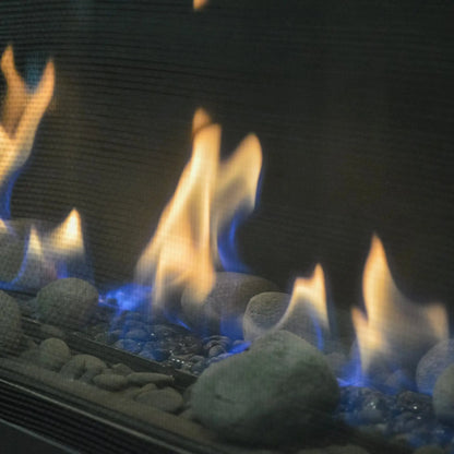 Close-up of gas flames over river stones in a Sierra Flame Boston fireplace