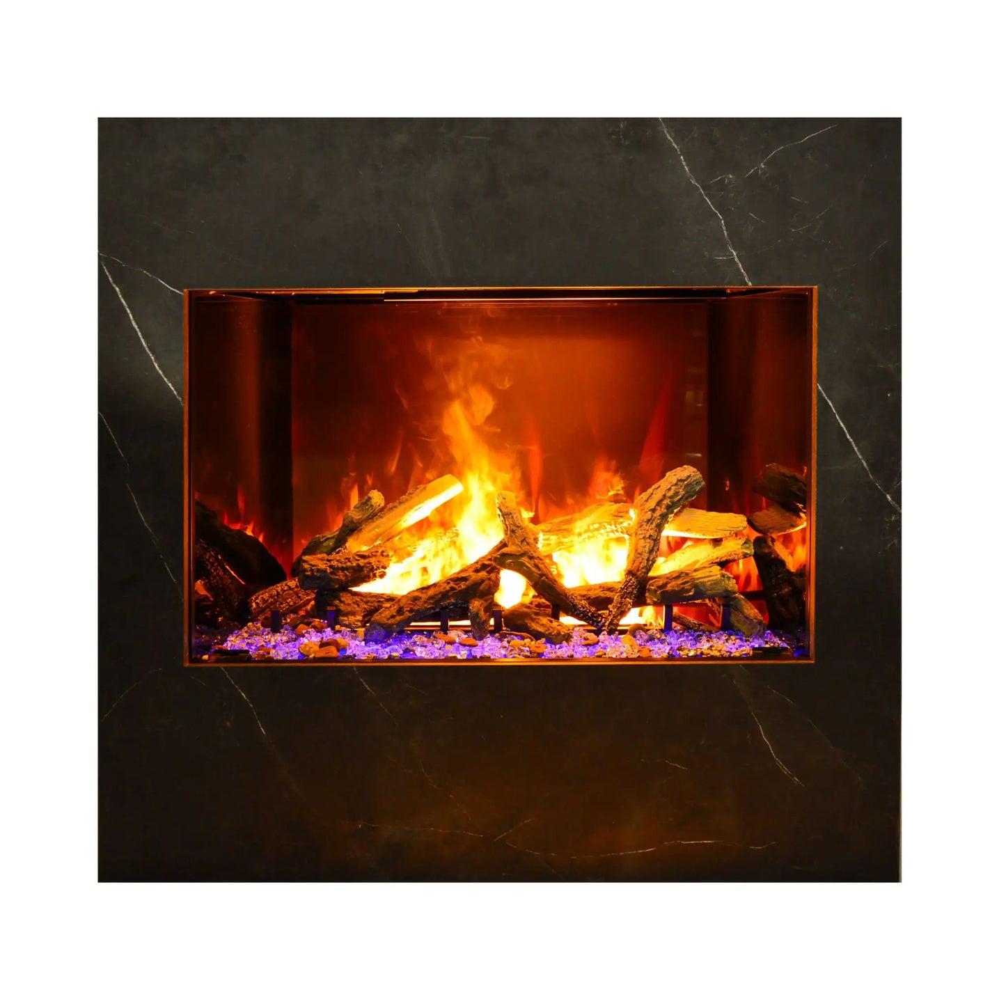 A modern electric fireplace insert with glowing orange and yellow flames, faux logs, and purple glass stones, set within a dark charcoal marble-look surround.