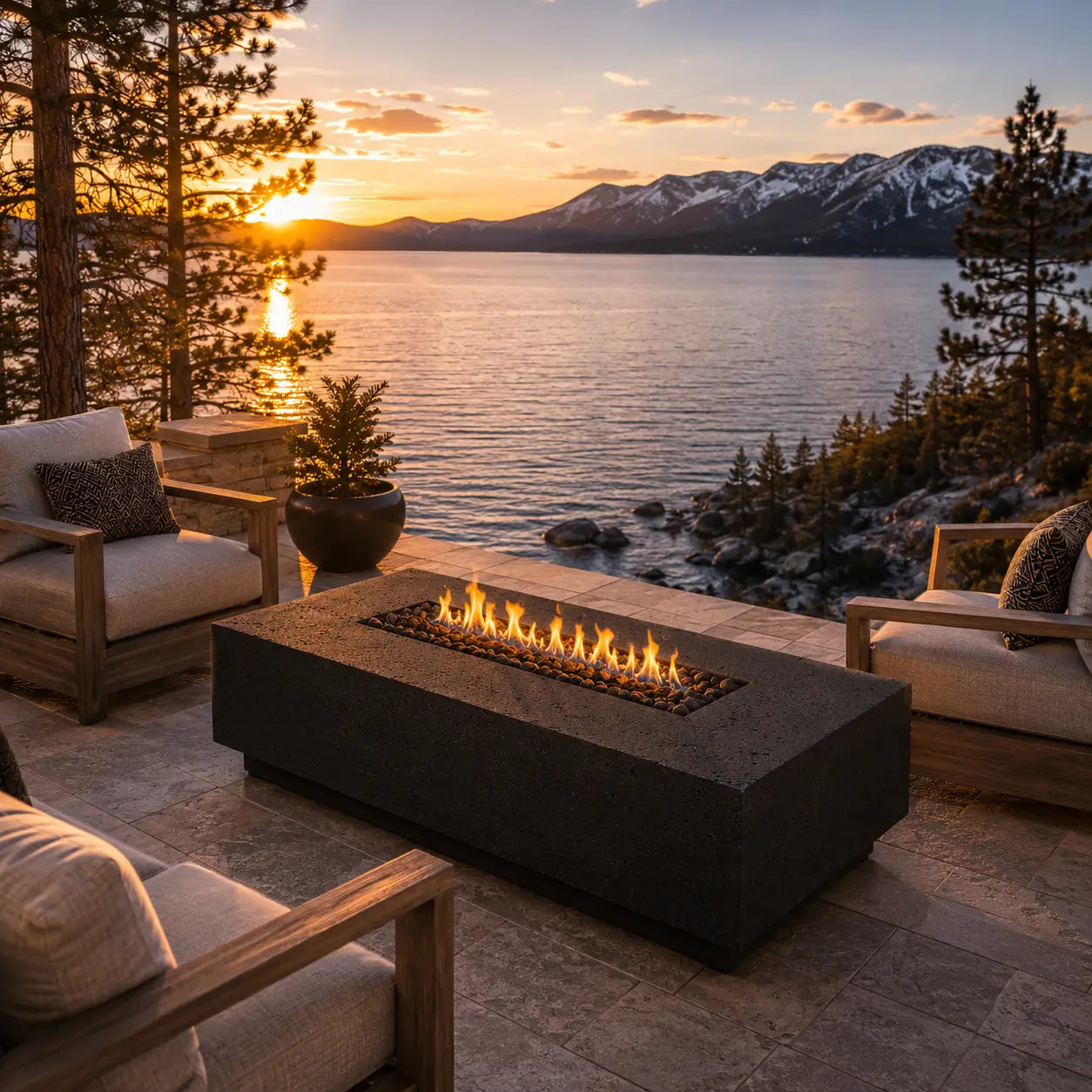 Outdoor fire pit by a lake with sunset and mountains in the background